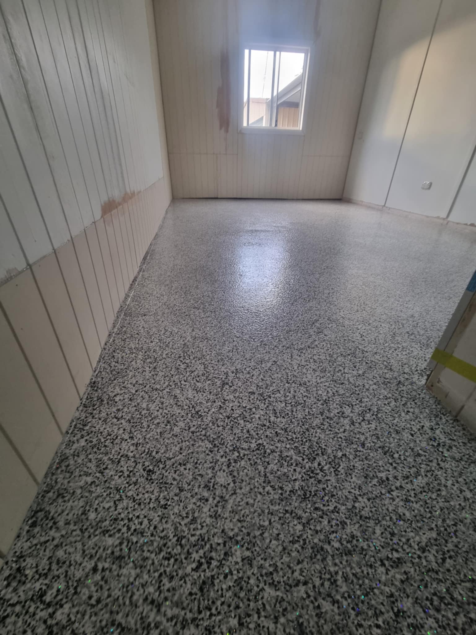 Completed epoxy garage floor with a flake finish