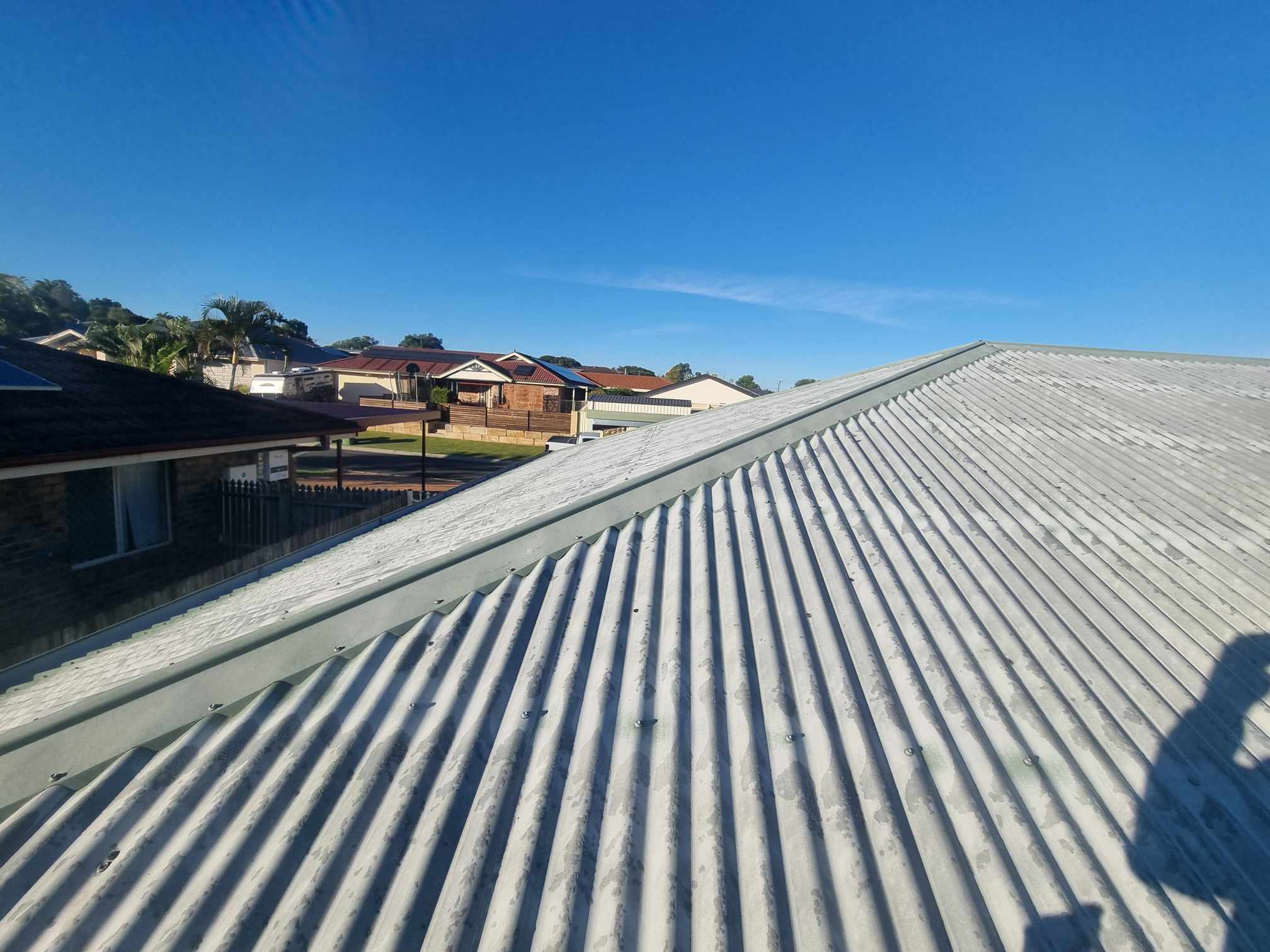 Weathered roof before restoration, showing grime and faded colour