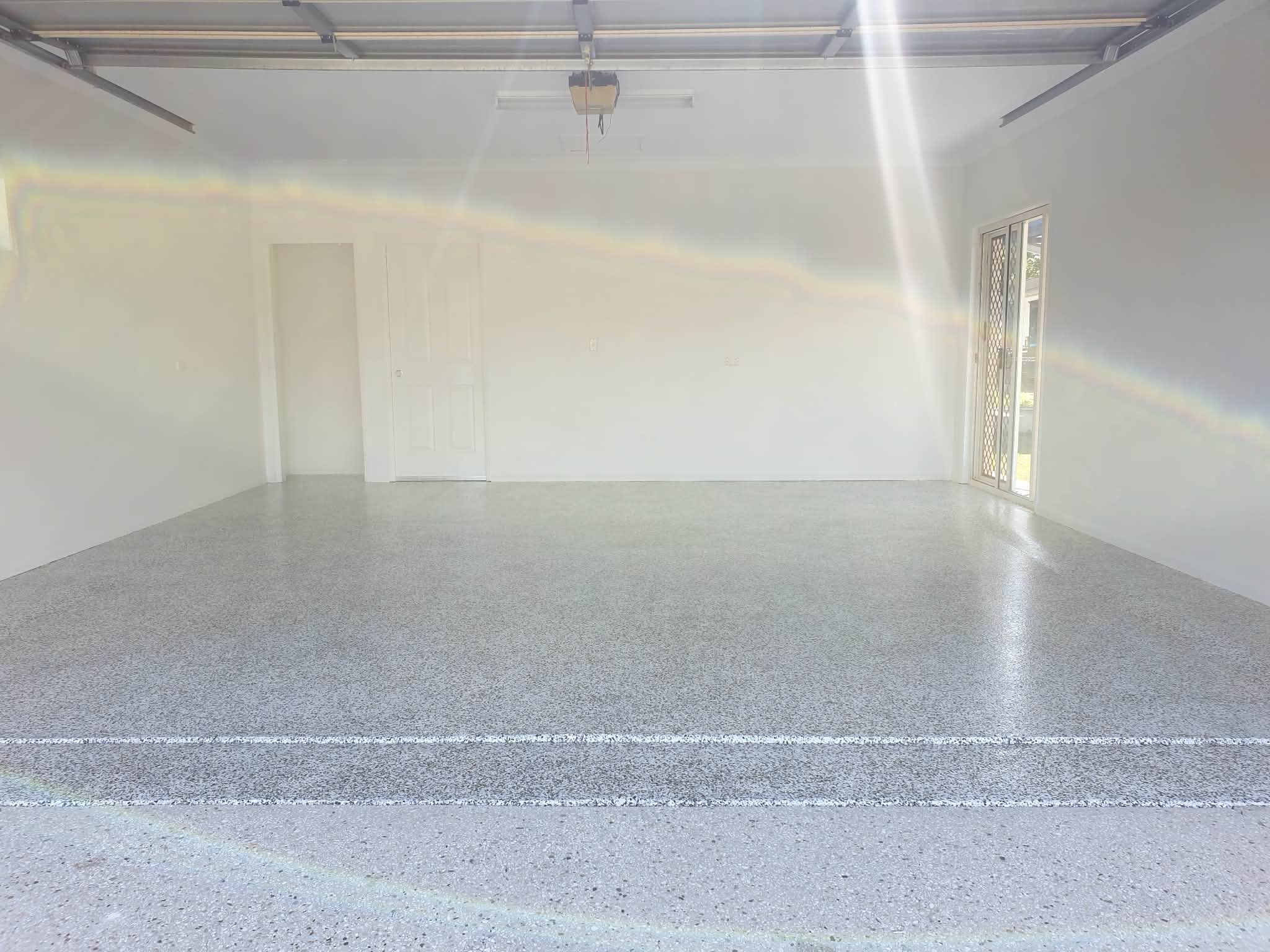 Grinding and patching a garage slab ready for coating