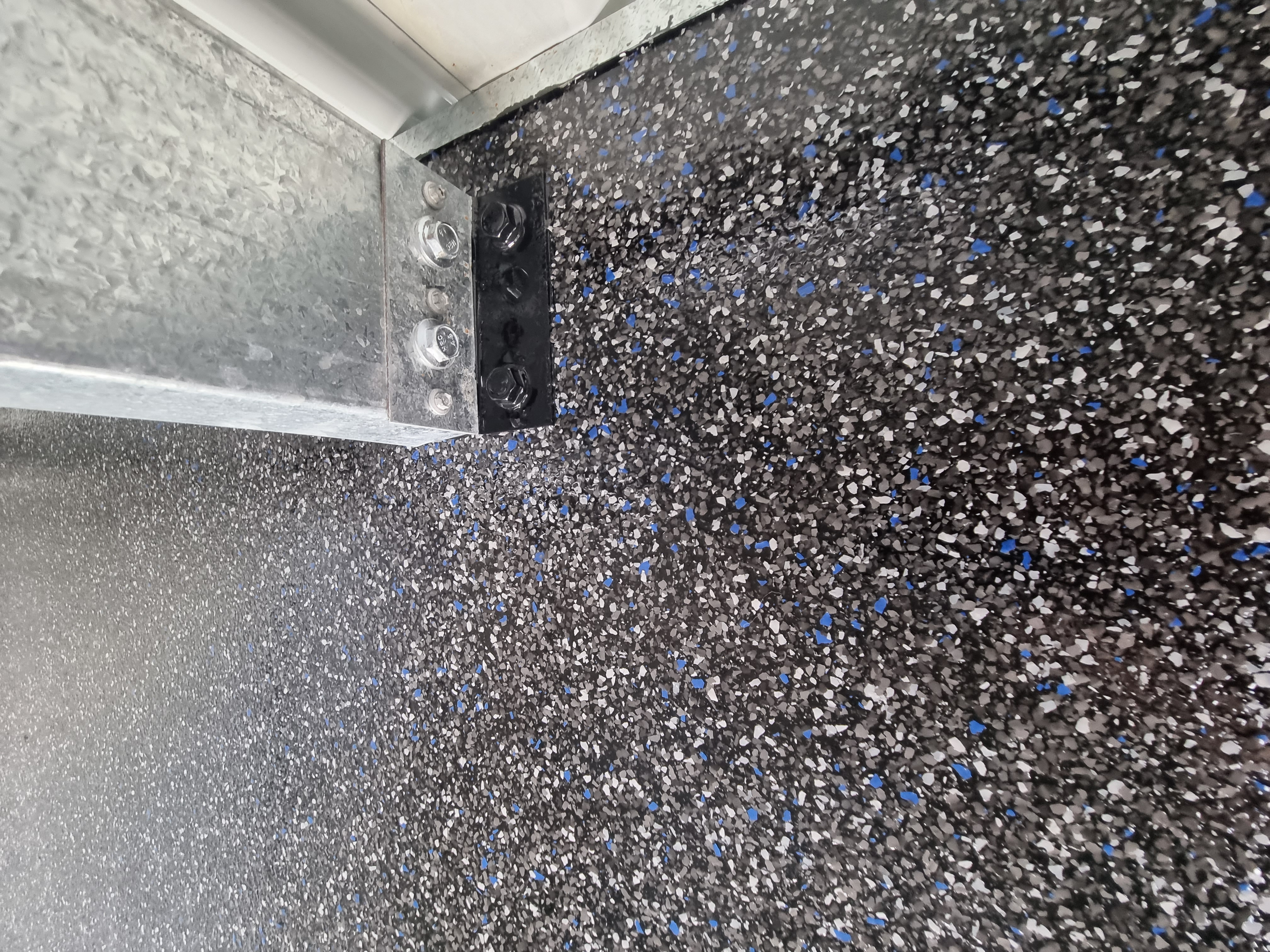 Applying epoxy floor coating to a prepared garage slab
